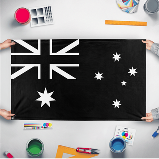 A mockup of the custom flag 'Black Australia Flag' held up on a table during print checking