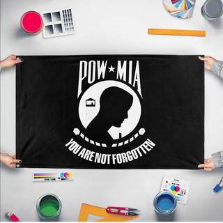 A mockup of the custom flag 'POW-MIA Flag' held up on a table during print checking