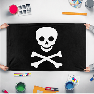 A mockup of the custom flag 'Jolly Roger Flag' held up on a table during print checking