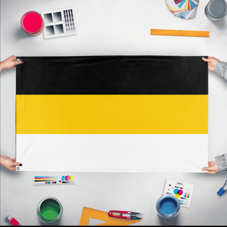 A mockup of the custom flag 'Russian Empire 1858 Flag' held up on a table during print checking