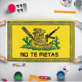 A mockup of the custom flag 'No te METAS  flag' held up on a table during print checking