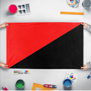 A mockup of the custom flag 'Anarchy Flag' held up on a table during print checking