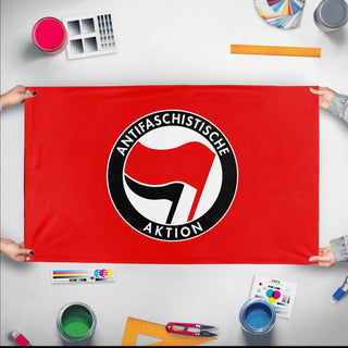 A mockup of the custom flag 'Anti-Fascist Flag' held up on a table during print checking