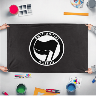 A mockup of the custom flag 'Anti-Fascist Flag' held up on a table during print checking