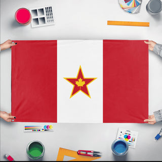 A mockup of the custom flag 'Socialist Canada Flag' held up on a table during print checking