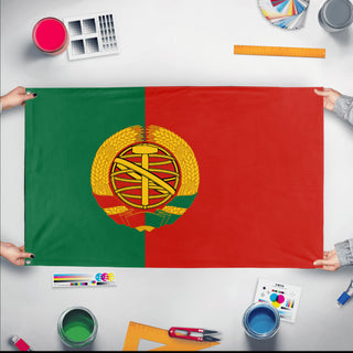 A mockup of the custom flag 'Socialist Portugal Flag' held up on a table during print checking