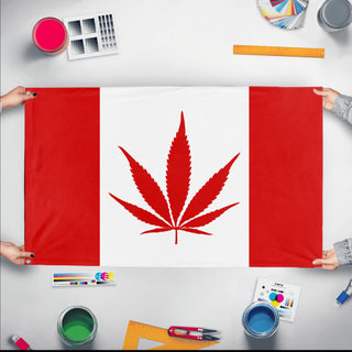 A mockup of the custom flag 'Canada Weed Flag' held up on a table during print checking