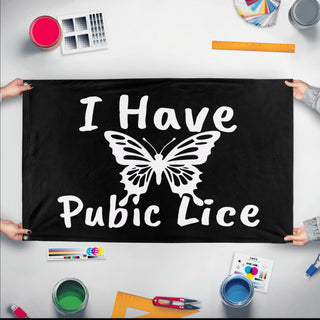 A mockup of the custom flag 'I Have Pubic Lice Flag' held up on a table during print checking