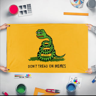 A mockup of the custom flag 'Don't Tread On Memes Flag' held up on a table during print checking