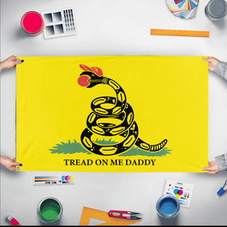 A mockup of the custom flag 'Please Tread On Me Daddy Flag' held up on a table during print checking