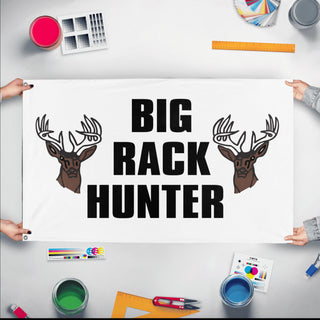A mockup of the custom flag 'Big Rack Hunter flag' held up on a table during print checking