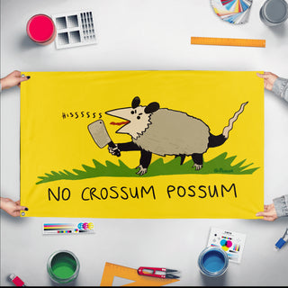 A mockup of the custom flag 'No Crossum The Possum Flag' held up on a table during print checking