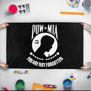 A mockup of the custom flag 'Flag of the missing soldier flag' held up on a table during print checking