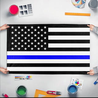 A mockup of the custom flag 'Thin Blue Line Flag' held up on a table during print checking