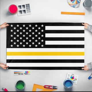 A mockup of the custom flag 'Thin Gold Line Flag' held up on a table during print checking