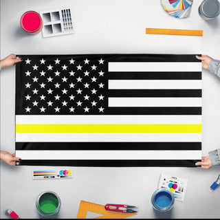 A mockup of the custom flag 'Thin Yellow Line Flag' held up on a table during print checking