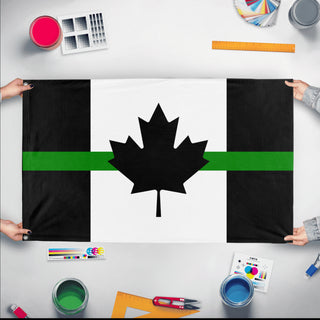 A mockup of the custom flag 'Thin Green Line Canada Flag' held up on a table during print checking