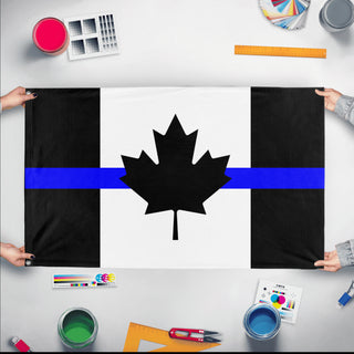 A mockup of the custom flag 'Thin Blue Line Canada Flag' held up on a table during print checking