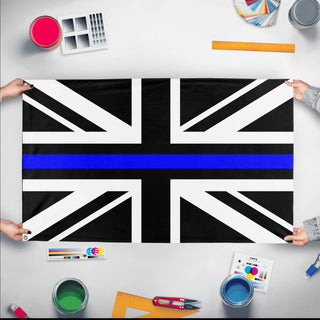 A mockup of the custom flag 'Thin Blue Line United Kingdom Flag' held up on a table during print checking