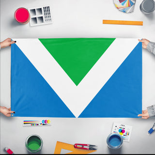 A mockup of the custom flag 'International Vegan Flag' held up on a table during print checking