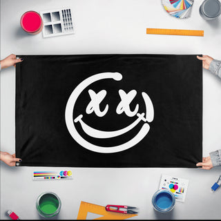 A mockup of the custom flag 'Rave Smile Flag' held up on a table during print checking