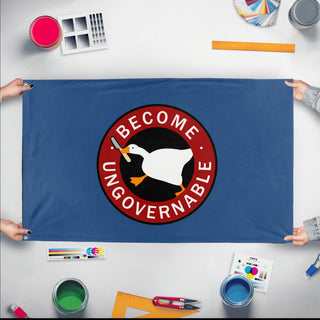 A mockup of the custom flag 'Become Ungovernable flag' held up on a table during print checking