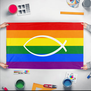 A mockup of the custom flag 'Jesus Fish Pride Flag' held up on a table during print checking