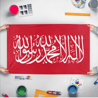 A mockup of the custom flag 'Islamic Shahada Flag - Red flag' held up on a table during print checking
