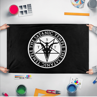 A mockup of the custom flag 'Satanic Baphomet Flag' held up on a table during print checking