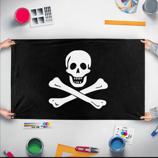 A mockup of the custom flag 'Jolly Roger - Classic Flag' held up on a table during print checking