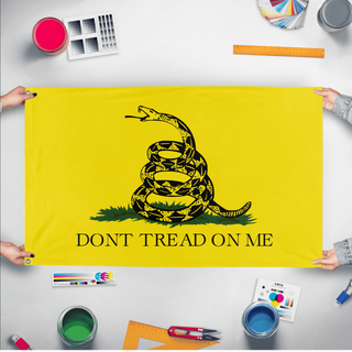A mockup of the custom flag 'Gadsden Flag' held up on a table during print checking