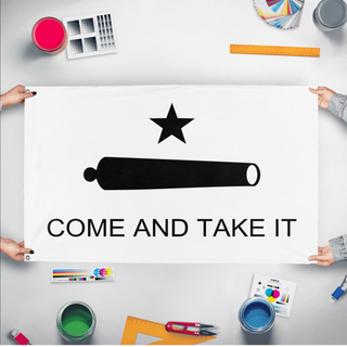 A mockup of the custom flag 'Gonzales "Come and Take It" Flag' held up on a table during print checking