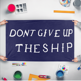 A mockup of the custom flag 'Commodore Perry "Don't Give Up the Ship" Flag' held up on a table during print checking