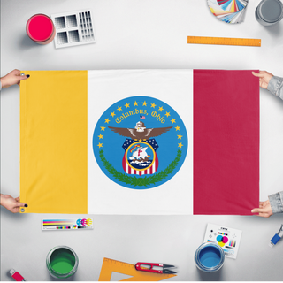 A mockup of the custom flag 'Columbus Flag' held up on a table during print checking