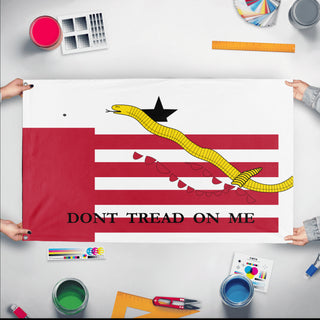 A mockup of the custom flag 'T flag' held up on a table during print checking