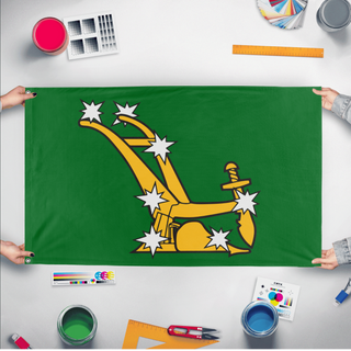 A mockup of the custom flag 'Starry Plough flag' held up on a table during print checking