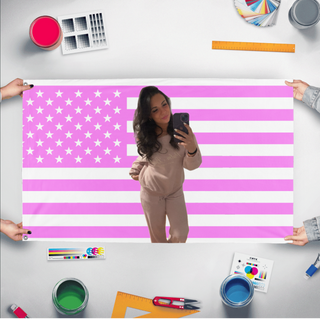 A mockup of the custom flag 'Raquel flag' held up on a table during print checking