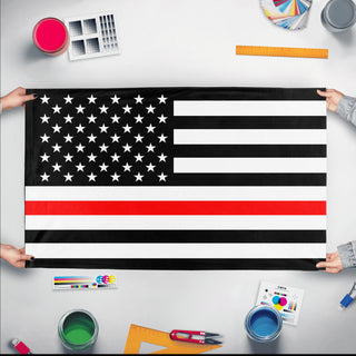 A mockup of the custom flag 'Thin Red Line flag' held up on a table during print checking