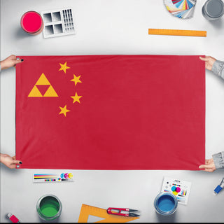 A mockup of the custom flag 'People's Republic of Hyrule flag' held up on a table during print checking