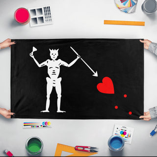 A mockup of the custom flag 'Blackbeard flag' held up on a table during print checking