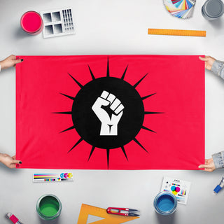 A mockup of the custom flag 'soleil noir flag' held up on a table during print checking