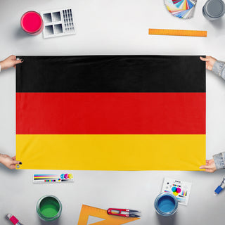 A mockup of the custom flag 'Germany flag' held up on a table during print checking