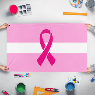 A mockup of the custom flag 'Latvian Breast Cancer Awareness flag' held up on a table during print checking