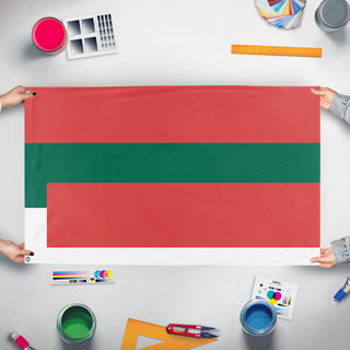 A mockup of the custom flag 'T flag' held up on a table during print checking