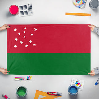 A mockup of the custom flag 'T flag' held up on a table during print checking