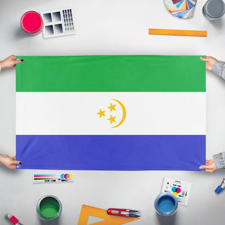 A mockup of the custom flag 'United Republic Of Osavina Vertical flag' held up on a table during print checking