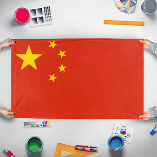 A mockup of the custom flag 'china flag' held up on a table during print checking