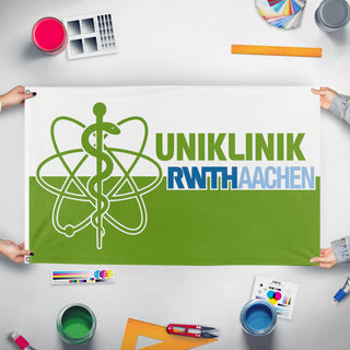A mockup of the custom flag 'RWTHStrahlentherapie flag' held up on a table during print checking