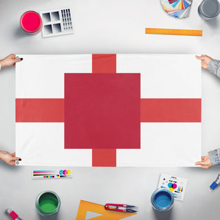 A mockup of the custom flag 'T flag' held up on a table during print checking