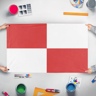 A mockup of the custom flag 't t flag' held up on a table during print checking